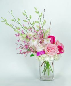 Blush Orchids highlight this gorgeous hand designed floral Bouquet. We fill out this arrangement with hydrangea and shades of pink roses.