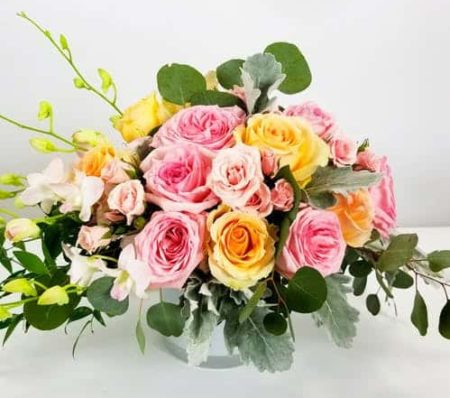 Garden Roses, roses, orchids, and dusty miller creates a beautiful garden display